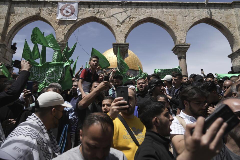 Palestinians chant slogans and wave Hamas flags after Friday prayers during the Muslim holy month of Ramadan, hours after Israeli police clashed with protesters at the Al Aqsa Mosque compound, in Jerusalem's Old City, Friday, April 22, 2022. (AP Photo/Mahmoud Illean)