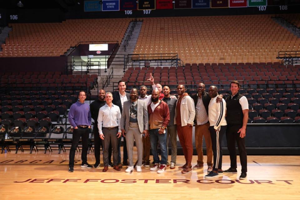 Jeff Foster, fourth from left, stands with members of the 1997 Southwest Texas State men's basketball team, which won the Southland Conference and played in the NCAA Tournament. Texas State renamed the court at Strahan Arena for Foster last Saturday.