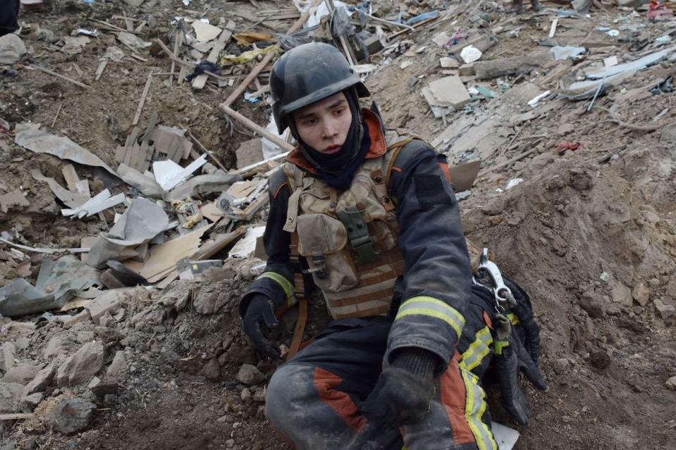 A Ukrainian State Emergency Service firefighter seen during a short pause during the inspection of a destroyed house after a Russian missile attack in Zaporizhzhia, Ukraine on March 23, 2024. (Andriy Andriyenko/SOPA Images/LightRocket via Getty Images)