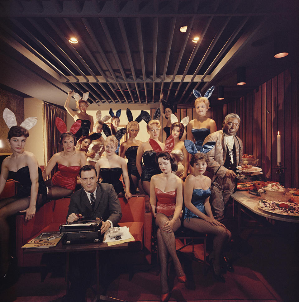 Premium Rates Apply. Working at his typewriter surrounded by 'bunny girls',  publisher Hugh M Hefner at the Playboy Key Club in Chicago. He founded adult magazines, Playboy, VIp and Oui.  (Photo by Slim Aarons/Getty Images)