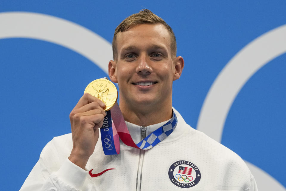 Caeleb Dressel, of United States, poses after winning the gold medal in the men's 100-meter butterfly final at the 2020 Summer Olympics, Saturday, July 31, 2021, in Tokyo, Japan. (AP Photo/Gregory Bull)