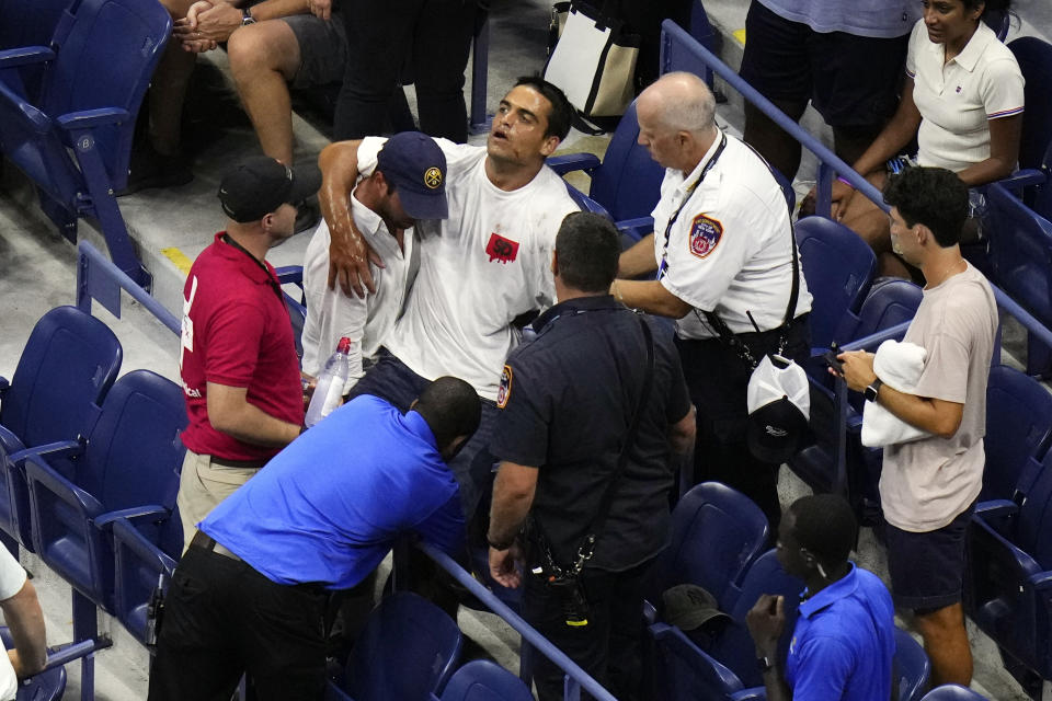 Medical workers tend to a patron that was having a medical issue during the quarterfinals match between Madison Keys, of the United States, and Marketa Vondrousova, of the Czech Republic, at the U.S. Open tennis championships, Wednesday, Sept. 6, 2023, in New York. (AP Photo/Frank Franklin II)