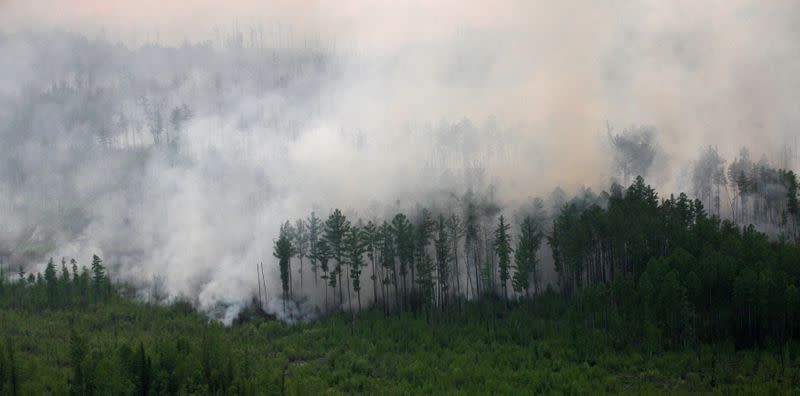 FILE PHOTO: An aerial view shows the Taiga wood burning near Boguchany