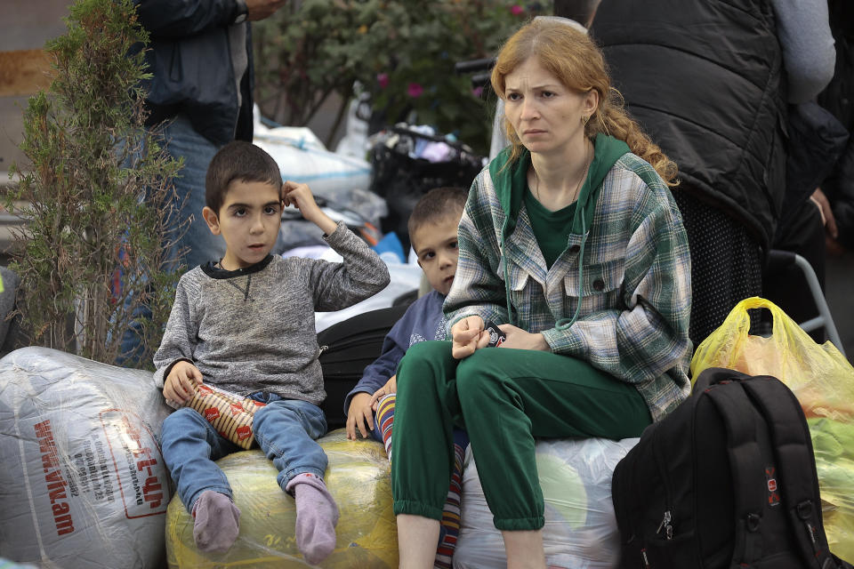 FILE - Ethnic Armenians from Nagorno-Karabakh sit after arriving in Armenia's Goris in Syunik region, Armenia, Thursday, Sept. 28, 2023. A human rights organization representing ethnic Armenians has submitted evidence to the International Criminal Court arguing that Azerbaijan is committing an ongoing genocide against them. (AP Photo/Vasily Krestyaninov, File)