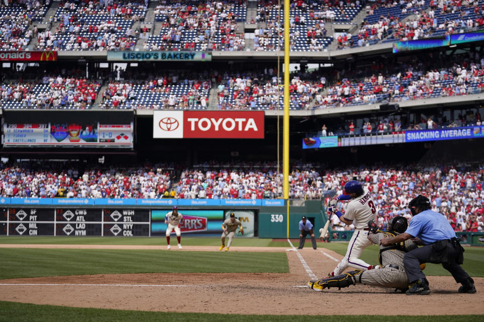 Philadelphia Phillies' Bryce Harper hits a run-scoring single against San Diego Padres pitcher Tim Hill during the eighth inning of the first baseball game in a doubleheader, Saturday, July 15, 2023, in Philadelphia. (AP Photo/Matt Slocum)
