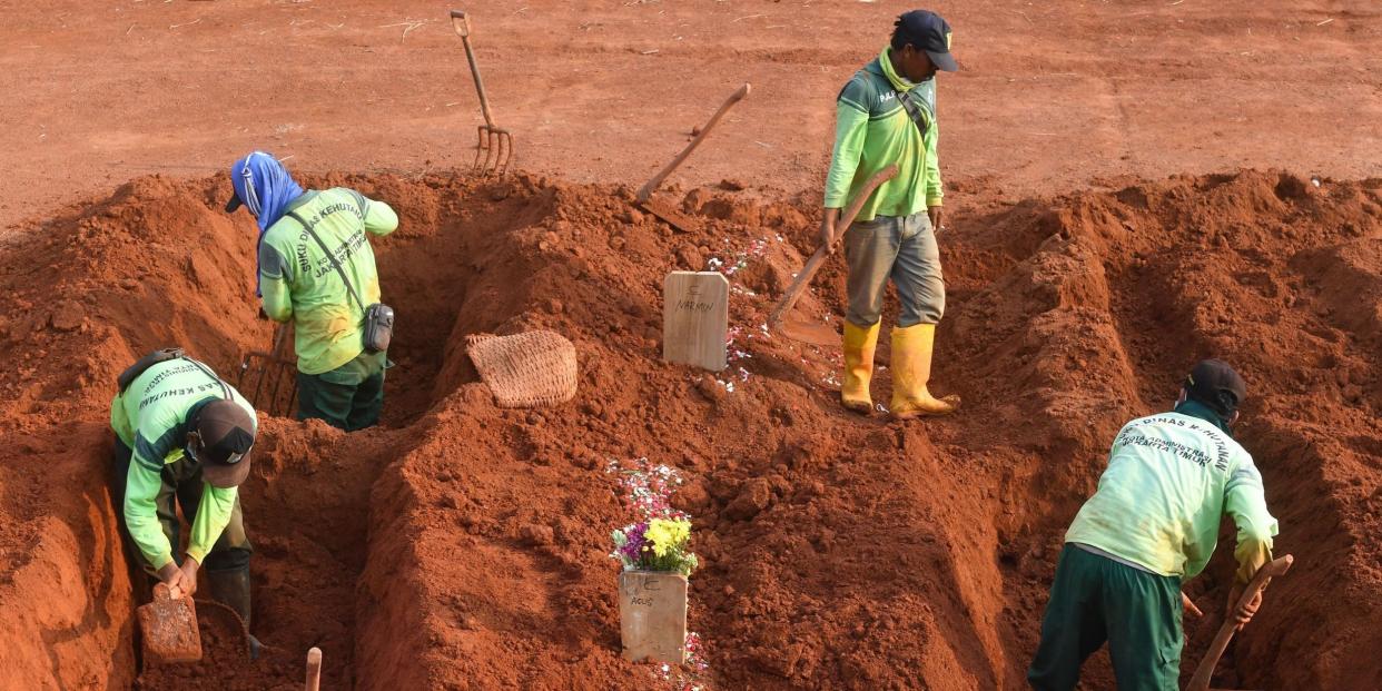 Gravediggers work at a burial plot for COVID-19 victims at the Pondok Ranggon cemetery in Jakarta on September 16, 2020.