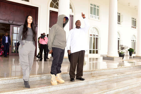 Rapper Kanye West (C) and Kim Kardashian (L) pose for a photograph with Uganda's President Yoweri Museveni when they paid a courtesy call at State House, Entebbe, Uganda October 15, 2018.