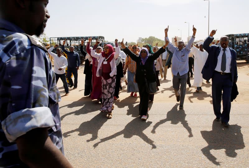 Supporters of Sudanese former president Omar Hassan al-Bashir shout slogans during a protest outside the court house that convicted him on corruption charges in Khartoum