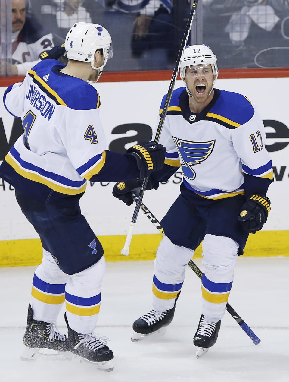 St. Louis Blues' Jaden Schwartz (17) celebrates with Carl Gunnarsson (4) after scoring against the Winnipeg Jets during the final minute of Game 5 of an NHL hockey first-round playoff series Thursday, April 18, 2019, in Winnipeg, Manitoba. (John Woods/The Canadian Press via AP)