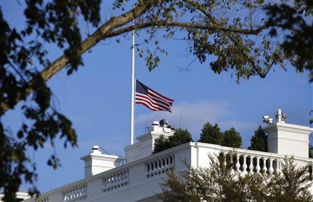 A U.S. flag flies at half staff at the White House September 16, 2013 in remembrance of victims of a shooting in the U.S. Navy Yard in Washington. REUTERS/Yuri Gripas