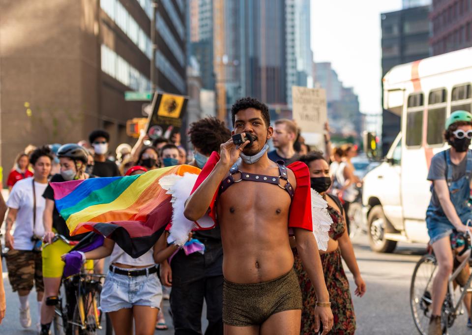 Rohan Zhou-Lee, founder of the Blasian March, leads a crowd in protest chants during a Pride rally on June 5.