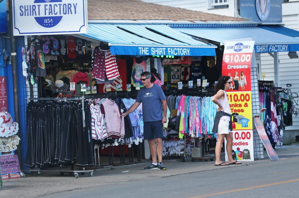 People walk and take a glance at the goods at Hampton Beach on Wednesday Sept. 14, 2022.