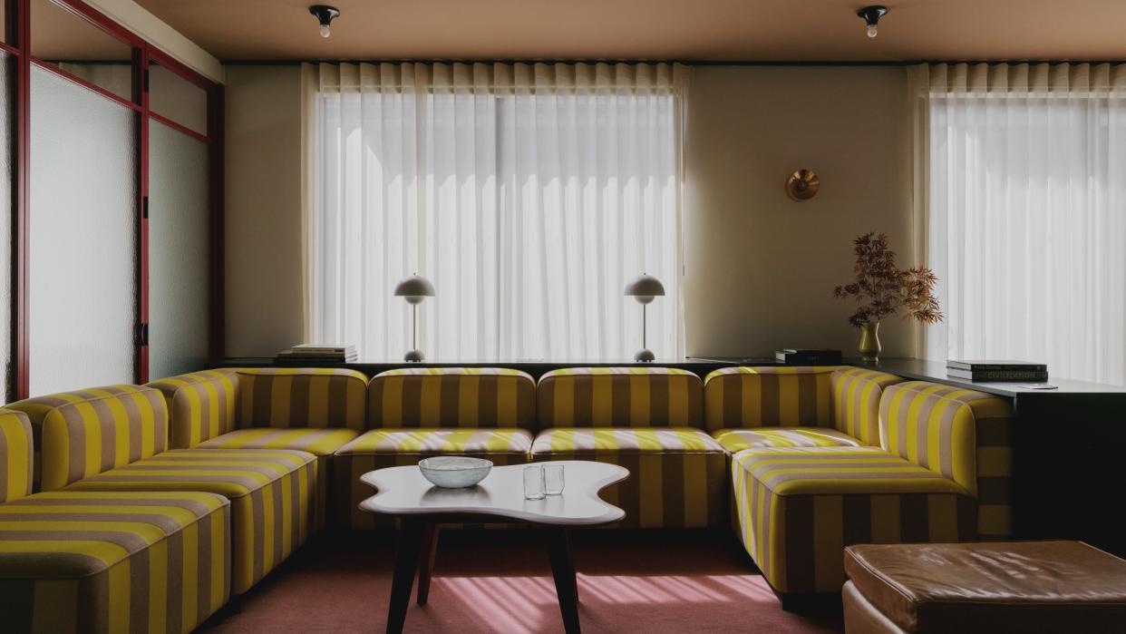  A striped yellow and grey sofa 