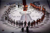 FILE - Minnesota Wild's Matt Dumba takes a knee during the national anthem flanked by Edmonton Oilers' Darnell Nurse, right, and Chicago Blackhawks' Malcolm Subban before an NHL hockey Stanley Cup playoff game in Edmonton, Alberta, Saturday, Aug. 1, 2020. Two years since Dumba took a knee to focus attention on society and the NHL's issues with racial intolerance, the Minnesota Wild defenseman no longer feels alone. (Jason Franson/The Canadian Press via AP, File)