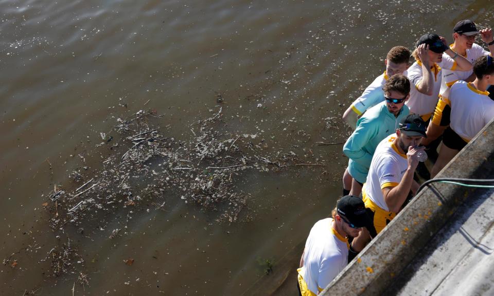 <span>Boat Race athletes stand by the dirty water at the finish where the coxes are usually thrown in.</span><span>Photograph: Tom Jenkins/The Guardian</span>