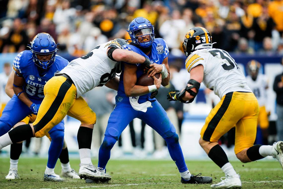 Kentucky Wildcats quarterback Destin Wade (15) is tackled by Iowa Hawkeyes defensive lineman Logan Lee (85) with the ball during the TransPerfect Music City Bowl in Nashville, Tn., Saturday, December 31, 2022.