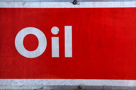 The word oil is pictured on an oil bank at a recycling yard in London March 2, 2011. REUTERS/Stefan Wermuth