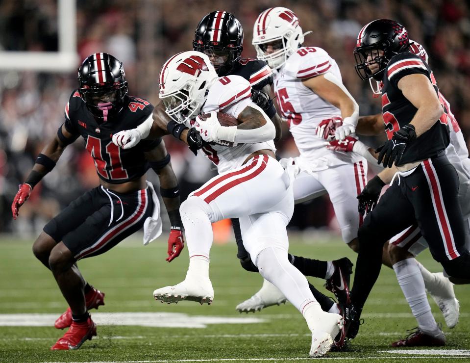 Sep 24, 2022; Columbus, Ohio, USA; Ohio State Buckeyes cornerback JK Johnson (4) tackles Wisconsin Badgers running back Braelon Allen (0) in the first quarter of the NCAA football game between Ohio State Buckeyes and Wisconsin Badgers at Ohio Stadium. 