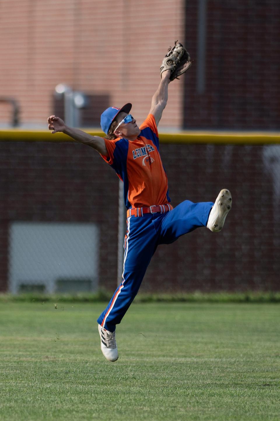 Leominster Post 151's Danny Wright makes a leaping catch in left field versus Hudson Post 100 on Friday.