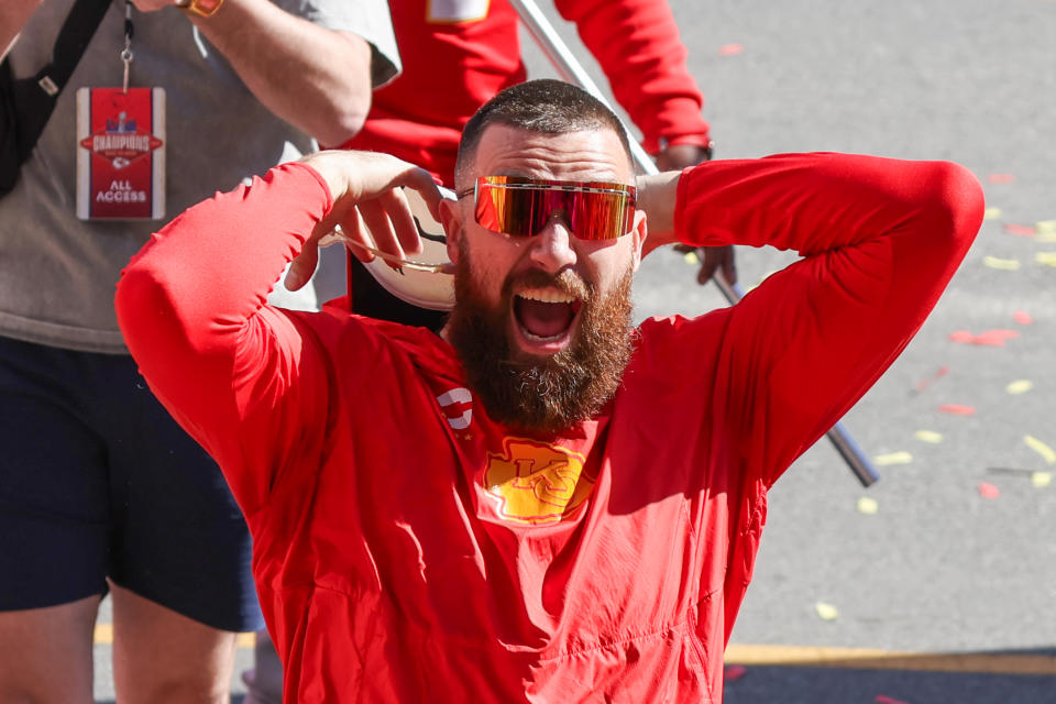 Travis Kelce yells and raises his hands to cheer up the crowd at the Kansas City Chiefs Super Bowl LVIII victory parade in Kansas City, Missouri in February. 