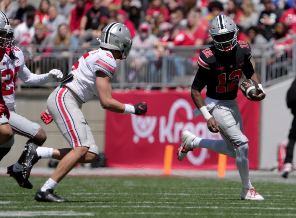 Ohio State quarterback Air Noland runs the ball while pursued by Aaron Scott Jr. on Saturday.