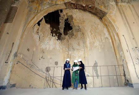 Afghan female engineers work on a map of the ruined Darul Aman palace in Kabul, Afghanistan October 2, 2016. REUTERS/Mohammad Ismail