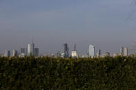 In this photo taken on Wednesday, Oct. 25, 2017, the skyline seen from the roof of Martini Terrace, in Milan, Italy. The eurozone's third-largest economy and a major exporter, Italy on Wednesday becomes the first western industrialized nation to idle swaths of industrial production to stop the spread of coronavirus by keeping yet more of the population at home. The new coronavirus causes mild or moderate symptoms for most people, but for some, especially older adults and people with existing health problems, it can cause more severe illness or death. (AP Photo/Luca Bruno, File)