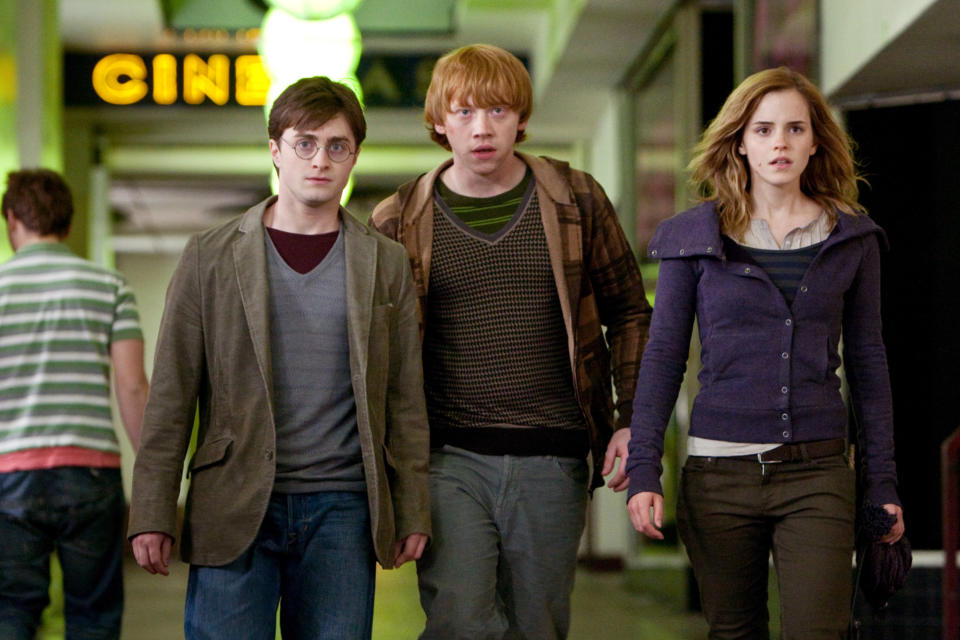 Harry, Ron, and Hermione walk through a Muggle building
