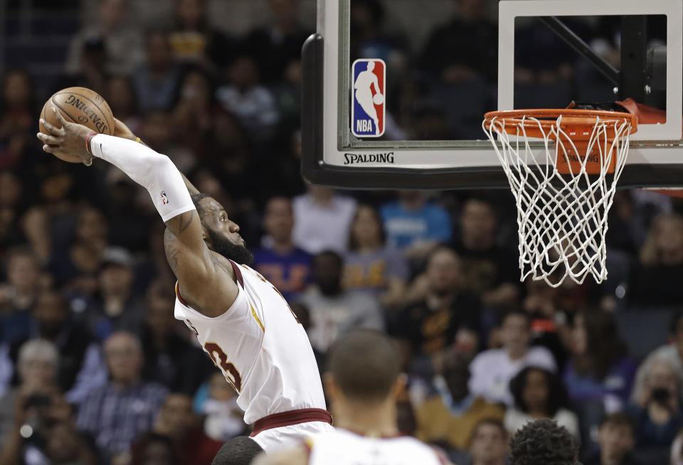 Cleveland Cavaliers’ LeBron James goes up to dunk against the Charlotte Hornets during the first half of an NBA basketball game in Charlotte, N.C., Wednesday, March 28, 2018. (AP Photo/Chuck Burton)