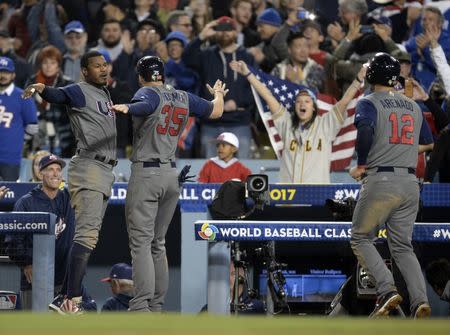 Mar 22, 2017; Los Angeles, CA, USA; USA outfielder Adam Jones (10) congratulates infielder Nolan Arenado (12) and infielder Eric Hosmer (35) after both score runs against Puerto Rico in the seventh inning during the 2017 World Baseball Classic at Dodger Stadium. Gary A. Vasquez-USA TODAY Sports