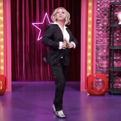 Derrick Barry in a suit entering the Werk Room