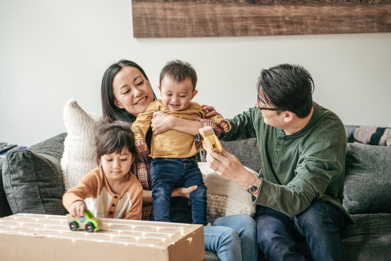 A Singaporean family of four spends time together in their home.