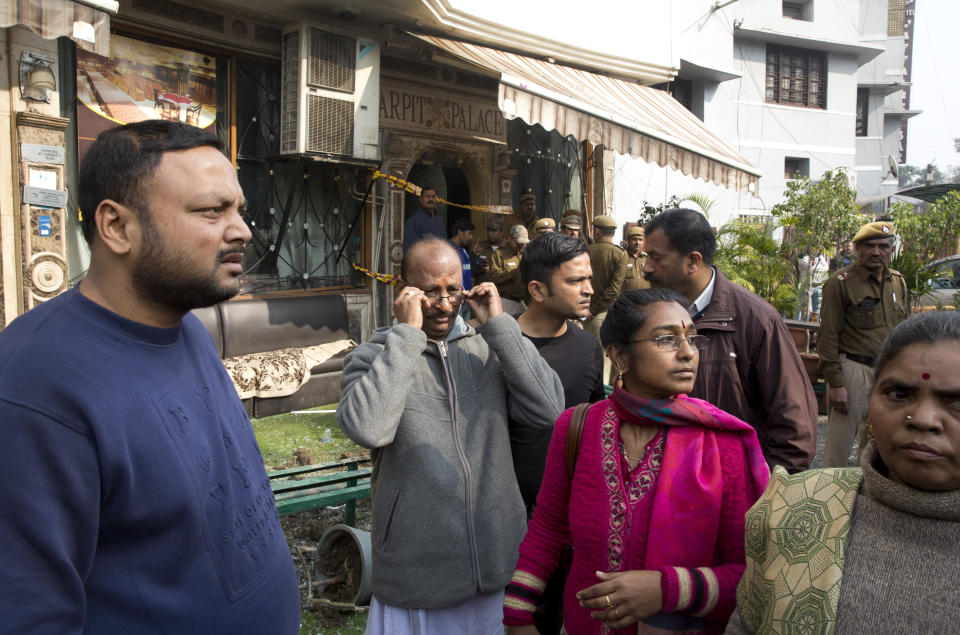 Hotel guests arrive to salvage their belongings after an early morning fire at a hotel killed more than a dozen people in the Karol Bagh neighborhood of New Delhi, India, Tuesday, Feb.12, 2019. (AP Photo/Manish Swarup)