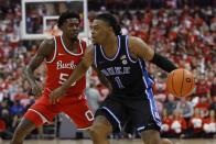 Duke's Trevor Keels, right, looks for an open pass as Ohio State's Jamari Wheeler defends during the first half of an NCAA college basketball game Tuesday, Nov. 30, 2021, in Columbus, Ohio. (AP Photo/Jay LaPrete)