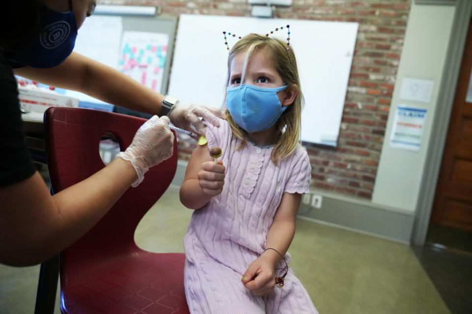 A child receives the Pfizer vaccine.