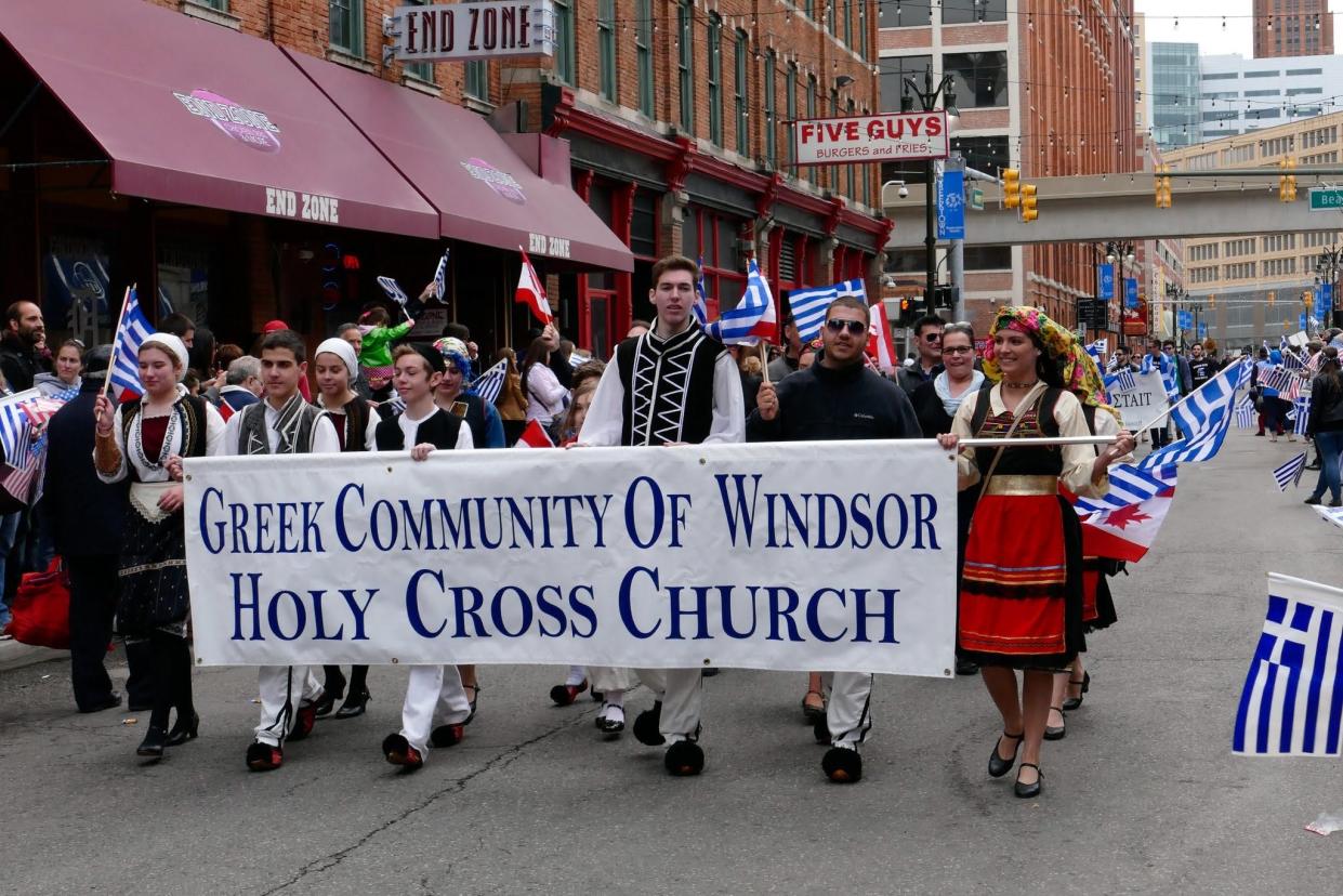 People marching in a past Detroit Greek Independence Day Parade in Greektown in downtown Detroit.