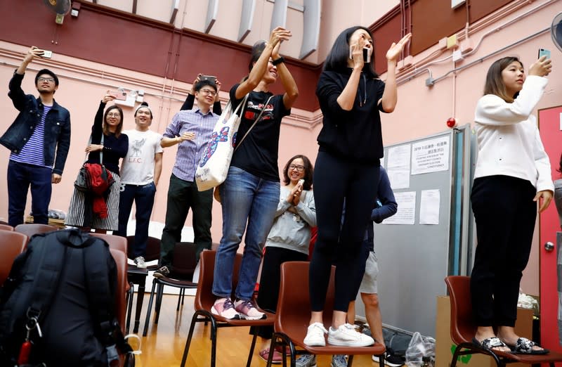 Supporters of local candidate Kelvin Lam celebrate at a polling station in the South Horizons West district in Hong Kong