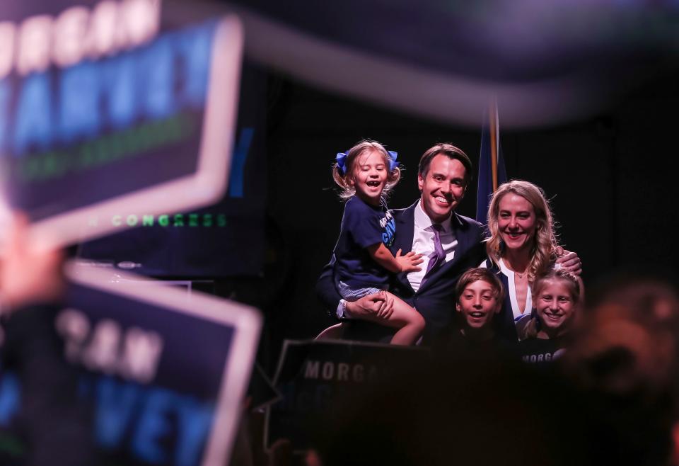 Kentucky state senator Morgan McGarvey holds youngest daughter Greta as he stands on stage with his son Wilson, wife Chris and daughter Clara after giving his victory speech after defeating Ky. Rep. Attica Scott to win the Democrat vote to replace retiring Rep. John Yarmuth-D.  May 17, 2022