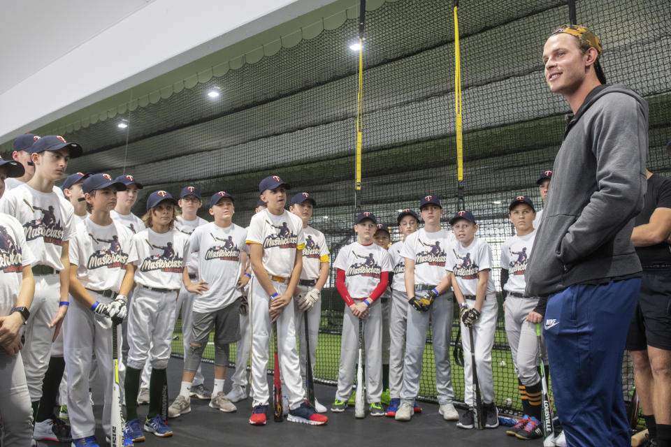 In this Saturday, Nov. 16, 2019 photo Minnesota Twins' Max Kepler, right, talks to young baseball players at an event at the Armin-Wolf-Arena in Regensburg, Germany. (Armin Weigel/dpa via AP)