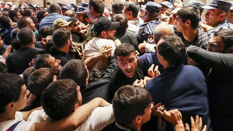 Demonstrators clash with police at the Armenia government building to protest against Prime Minister Nikol Pashinyan, Tuesday, Sept. 19, 2023, in Yerevan, Armenia. (Vahram Baghdasaryan/Photolure via AP)