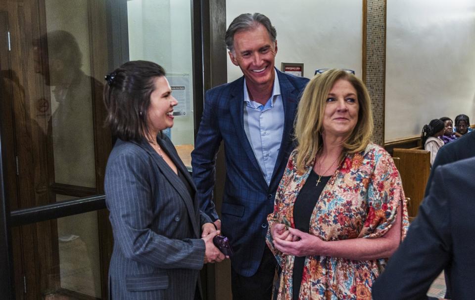 Kim and Deborah Clenney, the parents of the OnlyFans model Courtney Clenney, are seen with defense attorney Dianne Caramés, far left, after a hearing in front of Judge Laura Shearon Cruz, where the computer hacking charges against themselves and their daughter, OnlyFans model Courtney Clenney, were dismissed at the Gerstein Justice Building, Thursday, July 11, 2024, in Miami. Courtney Clenney is accused of stabbing to death her boyfriend in a Miami condo in 2022. The murder charge has not been dropped. (Pedro Portal/Miami Herald via AP)