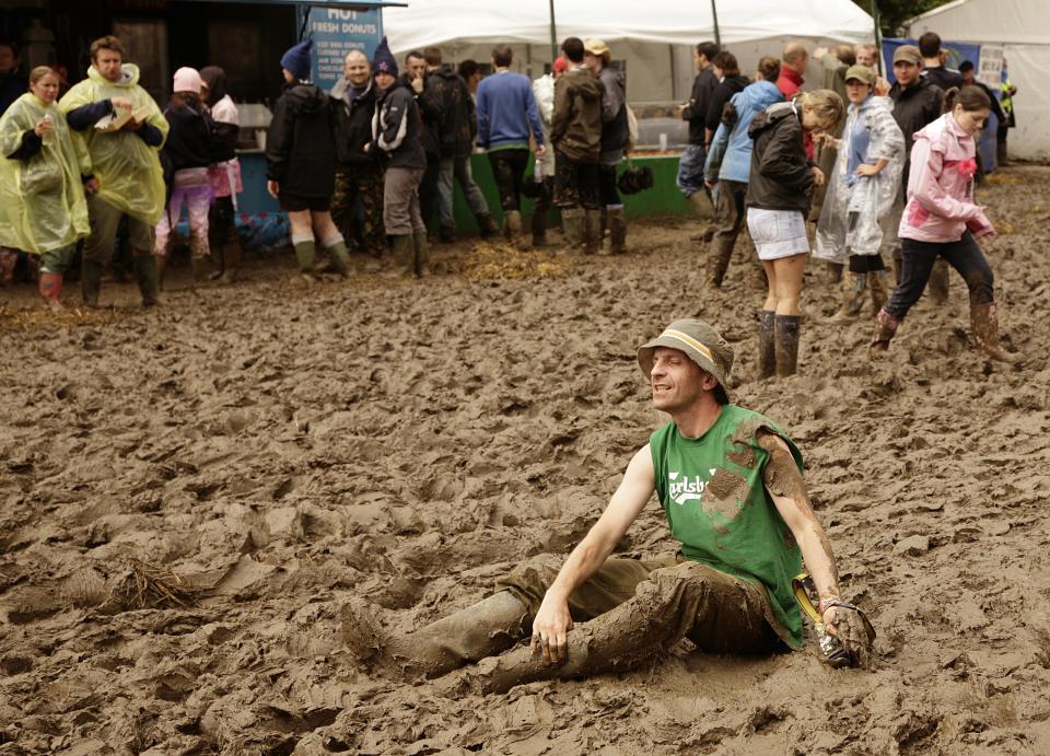 A view of the muddy and wet conditions at the 2007 Glastonbury Festival at Worthy Farm in Pilton, Somerset.   (Photo by Yui Mok - PA Images/PA Images via Getty Images)