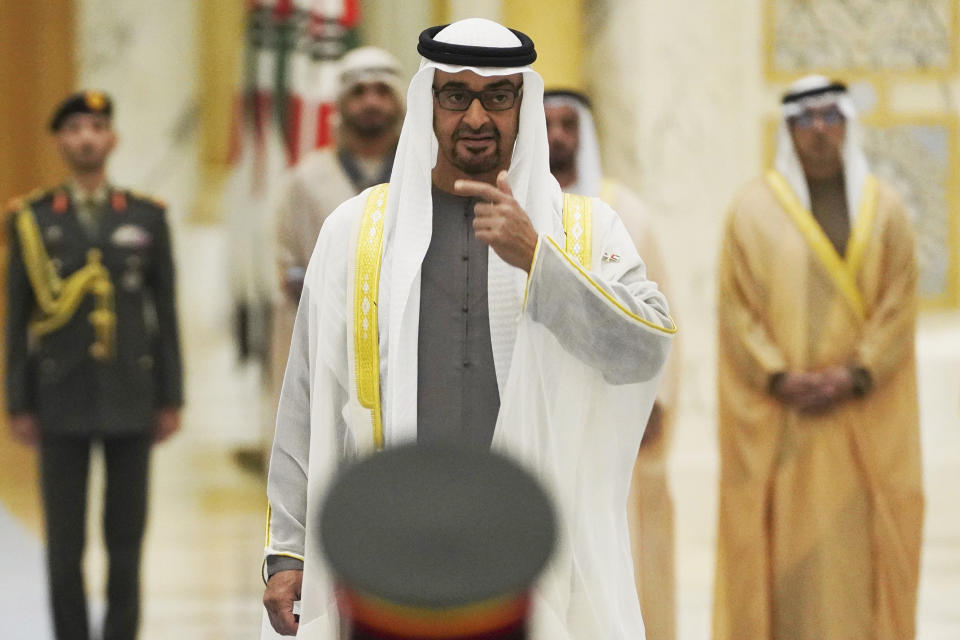 FILE - Emirati leader Sheikh Mohammed bin Zayed Al Nahyan gestures toward an honor guard at Qasar Al Watan in Abu Dhabi, United Arab Emirates, on Jan. 15, 2023. Sheikh Mohammed bin Zayed Al Nahyan, appointed his eldest son Khaled as crown prince of Abu Dhabi on Wednesday March 29, 2023, placing him as next in line to take over as the leader of the federation. (AP Photo/Jon Gambrell, File)