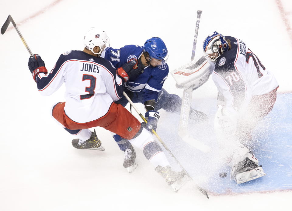 Columbus Blue Jackets defenseman Seth Jones (3) picks up a holding call as Tampa Bay Lightning center Anthony Cirelli (71) makes a short handed breakaway attempt on Jackets goaltender Joonas Korpisalo (70) during the second period in Game 1 of an NHL hockey Stanley Cup first-round playoff series, Tuesday, Aug. 11, 2020, in Toronto. (Frank Gunn/The Canadian Press via AP)