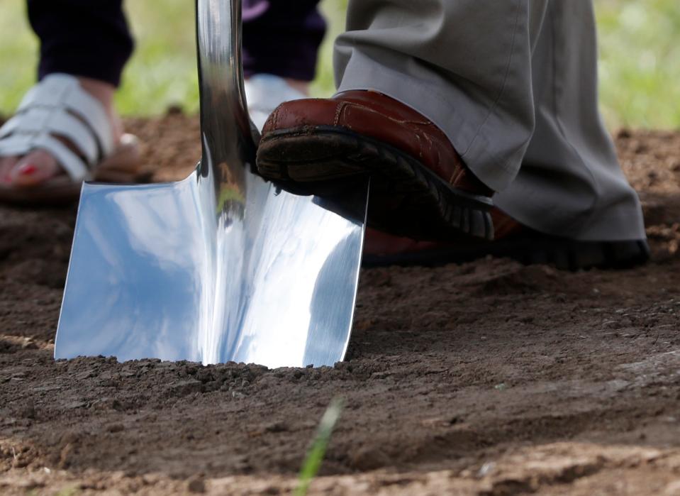 A shovel digs into the ground during the groundbreaking of the new Public Works Campus, Wednesday, Sept. 7, 2022, in Lafayette, Ind. 