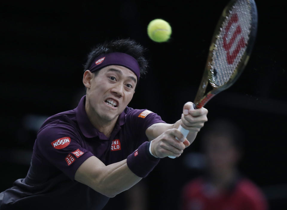 Kei Nishikori of Japan returns the ball to Roger Federer of Switzerland during their quarterfinal match of the Paris Masters tennis tournament at the Bercy Arena in Paris, France, Friday, Nov. 2, 2018. (AP Photo/Michel Euler)