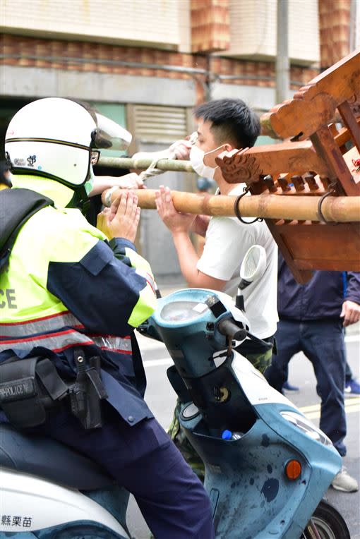 員警雙手合十祈禱，鑾轎轎身也做出回應。（圖／讀者陳淑惠提供）