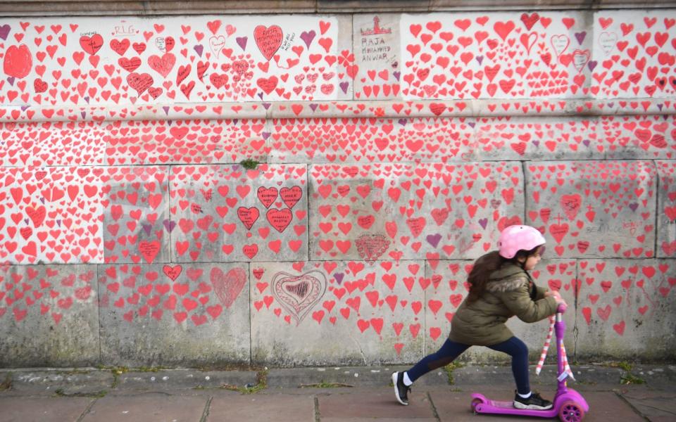 More than one thousand people, including the bereaved, NHS staff, volunteers and members of the public have painted 150,000 hearts on the wall - Victoria Jones/PA Wire