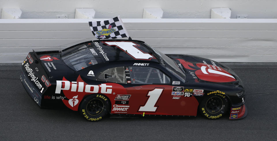 Michael Annett (1) drives with the checkered flag after winning the NASCAR Xfinity auto race Saturday, Feb. 16, 2019, at Daytona International Speedway in Daytona Beach, Fla. (AP Photo/Chris O'Meara)