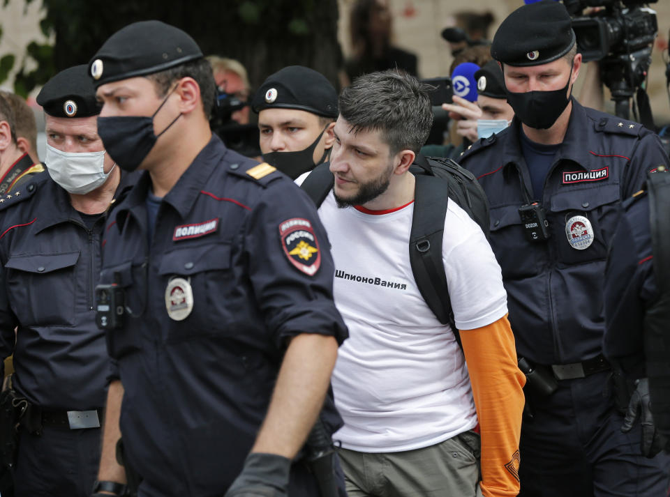 Police officers detain Peter Parkhomenko Kommersant journalist, during a rally to support Ivan Safronov near the Lefortovo prison in Moscow, Russia, Monday, July 13, 2020. Safronov, an ex-journalist who worked as an adviser to the director of Russia's state space corporation has been arrested and jailed on charges of passing military secrets to Czech intelligence. Ivan Safronov wrote about military and security issues before becoming an adviser to the head of Roscosmos. (AP Photo/Alexander Zemlianichenko)